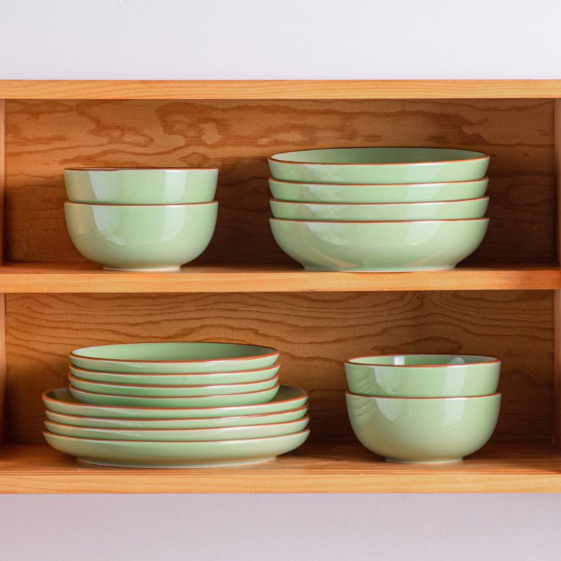 green ceramic plates inside dishwasher